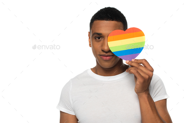 african american man obscuring face with lgbt colors paper heart isolated on white
