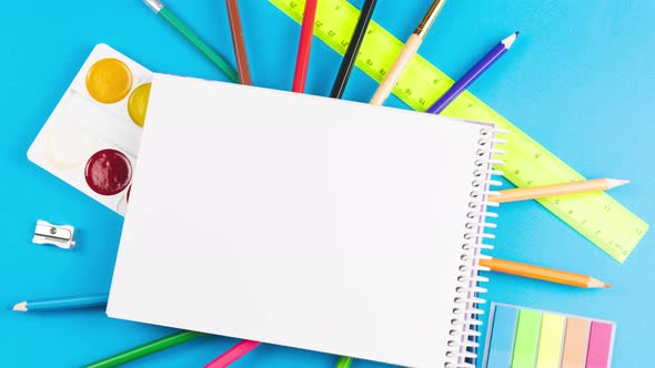 School Supplies for the First of September are on a Pastel Blue Background alt