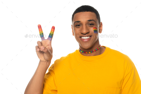 positive african american man with lgbt flag painted on face showing ...