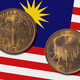 Malaysian ringgit coin, one sen on a national flag - PhotoDune Item for Sale