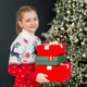Preteen child with gift boxes in room. Concept New Year, Merry Christmas, holiday, vacation, winter - PhotoDune Item for Sale
