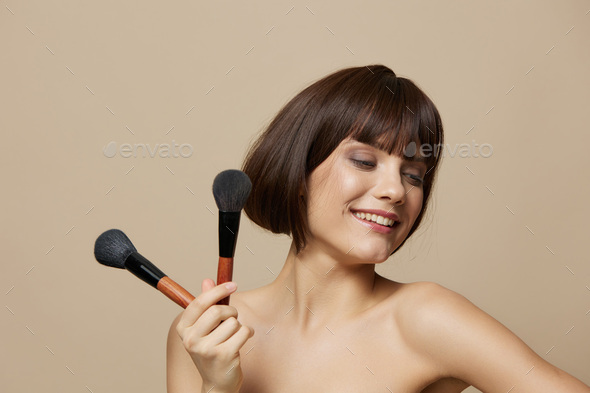 woman brushe cosmetics attractive look posing close-up Lifestyle - Stock Photo - Images