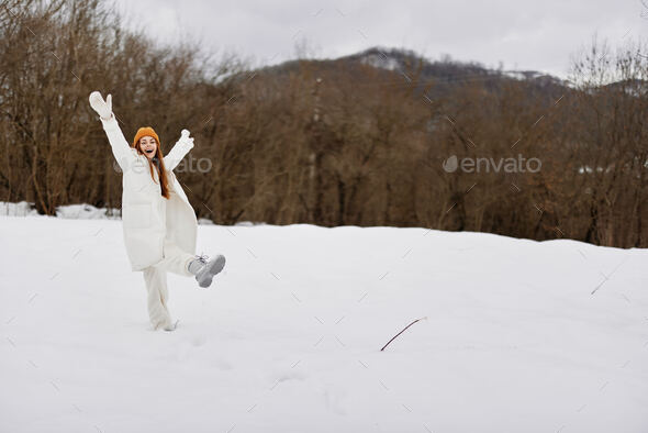 young woman in winter clothes in hats outdoors There is a lot of snow  around Stock Photo by shotprime