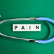 stethoscope and alphabet letters with the word pain.  - PhotoDune Item for Sale