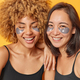 Indoor close up of two young pretty happy smiling European and African american ladies standing - PhotoDune Item for Sale