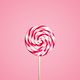 Colorful red and white lollipop candy on pastel pink background.  - PhotoDune Item for Sale