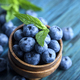 Bowl of fresh blueberries on blue rustic wooden table  - PhotoDune Item for Sale