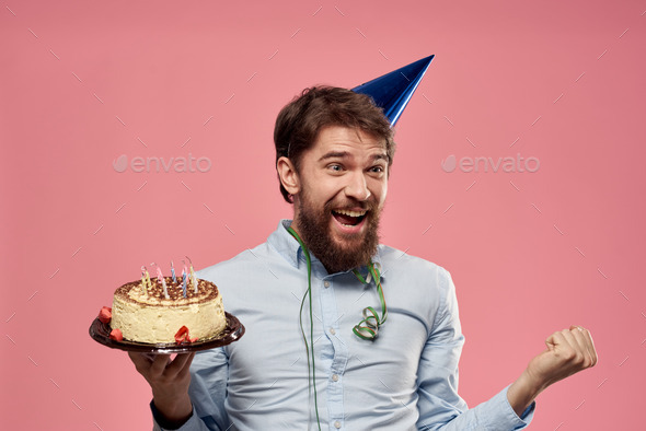 Bearded man with cake on pink background birthday party corporate emotions model loneliness