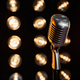 Classic vintage mic in front of blurred spotlights on black background. - PhotoDune Item for Sale