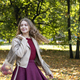 young girl with long blond hair in an autumn park with string bag with red apples - PhotoDune Item for Sale