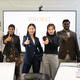 A group of multiracial businesspeople gives the thumbs up in front of the meeting room - PhotoDune Item for Sale