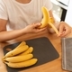 a woman peels a banana to make breakfast - PhotoDune Item for Sale