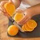 juicy orange slices in a woman&#39;s hands - PhotoDune Item for Sale
