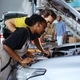 Repair shop workers fix car with pliers - PhotoDune Item for Sale