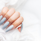 Grey nails on white lace background. - PhotoDune Item for Sale