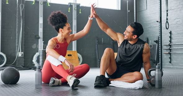 Fitness couple, high five and personal trainer with woman client to  celebrate achievement, success and goal after exercise. Man and woman  together at gym for partnership, health and wellness workout Stock Photo