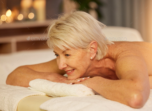 Happy woman, senior and relax on spa table for skincare treatment, holistic physical therapy and he