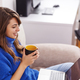 Woman drinking coffee while working from home - PhotoDune Item for Sale
