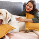 Woman relaxing at home with her pet dog - PhotoDune Item for Sale