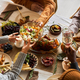 Multiethnic group of people at festive dinner table celebrating Thanksgiving - PhotoDune Item for Sale