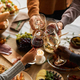 Friends at festive dinner table celebrating Thanksgiving together - PhotoDune Item for Sale