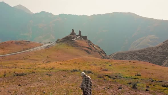 Fast Motion Fly Over Female Tourist In Kazbegi National Park alt
