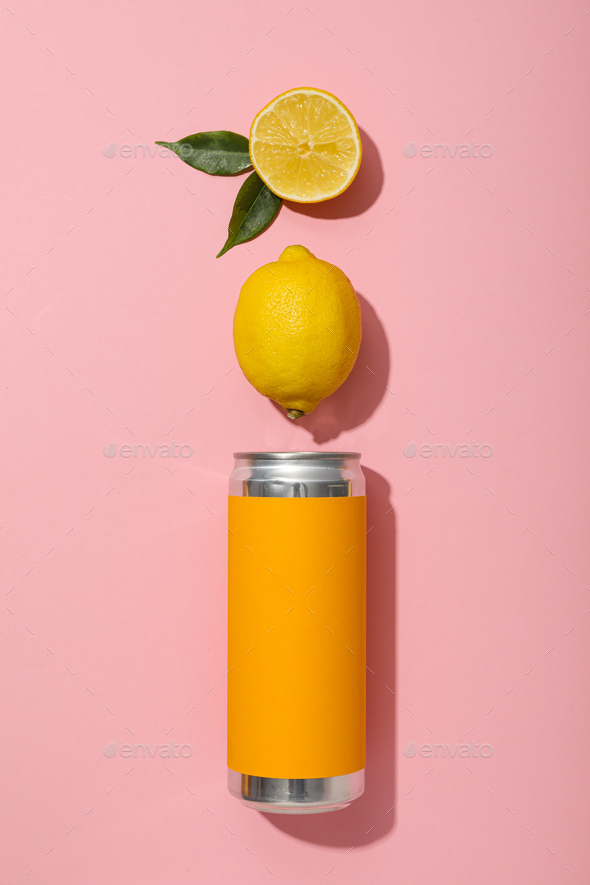 Tin can in orange label and lemons on pink background, top view