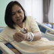 Middle-aged Asian female patient recovering from illness in hospital room, health care concept. - PhotoDune Item for Sale