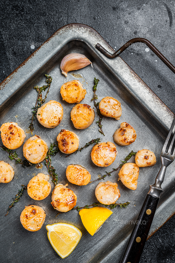 Scallops Poached In A Butter And Garlic Sauce In A Steel Tray With Thyme Black Background Top 2580