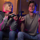 Young caucasian couple playing video game with game pads - PhotoDune Item for Sale