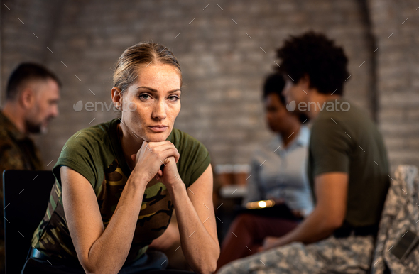 Portrait of female veteran in PTSD support group looking at camera.