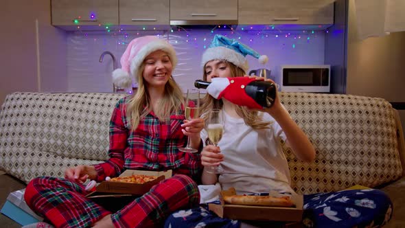 Beautiful Cheerful Girls in Pajamas Selebrates Holidays Alone at Home. Stylish Young Women Sitting
