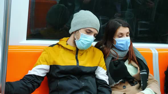 travel during covid - young couple wearing mask on the subway alt