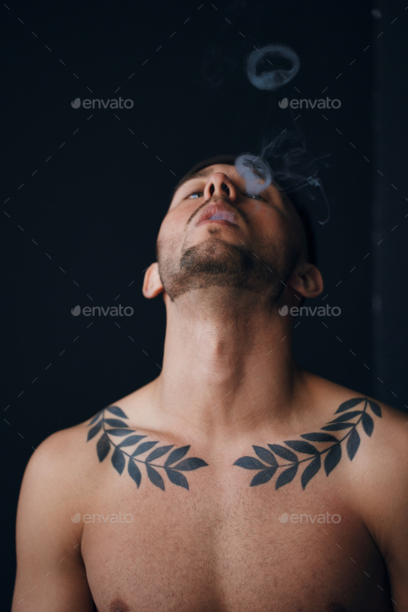 Modelling snapshots. Pensive focused tanned attractive handsome naked man tipping his head back