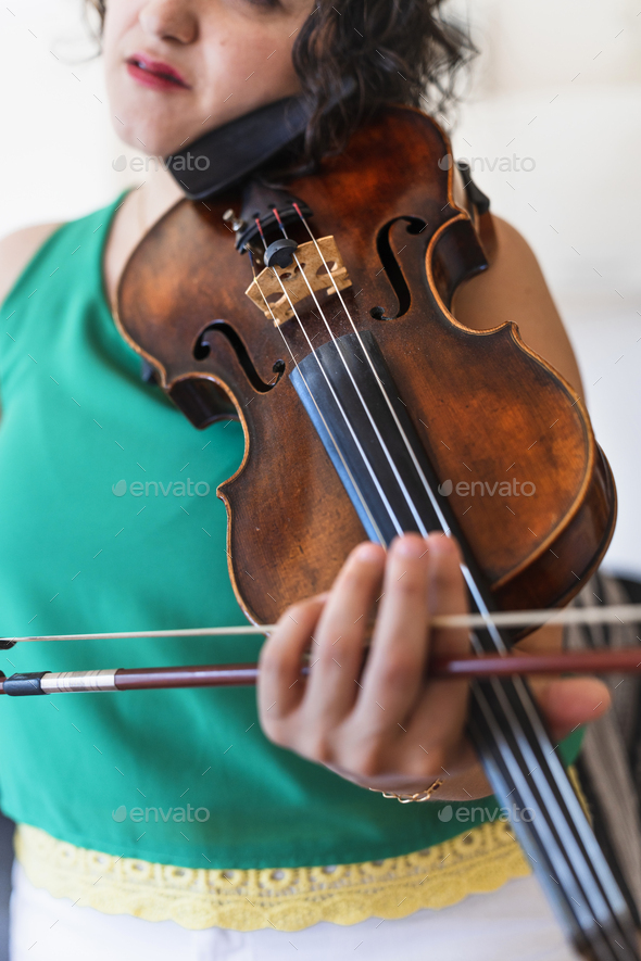 Vintage Virtuoso: Middle-aged Violinist Crafting Classical Tunes in Home