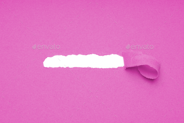 hole torn in pink paper to reveal hidden copy space
