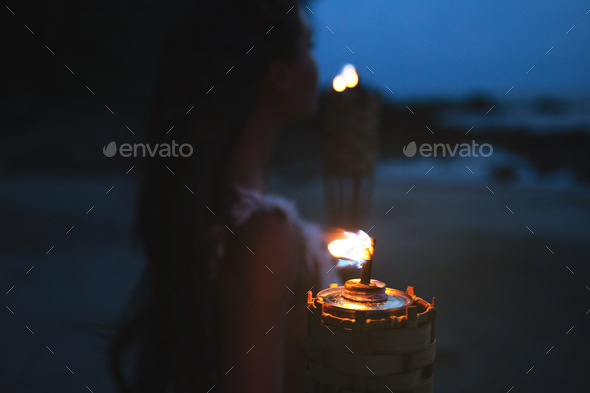 Close-up of bamboo torch light on the beach