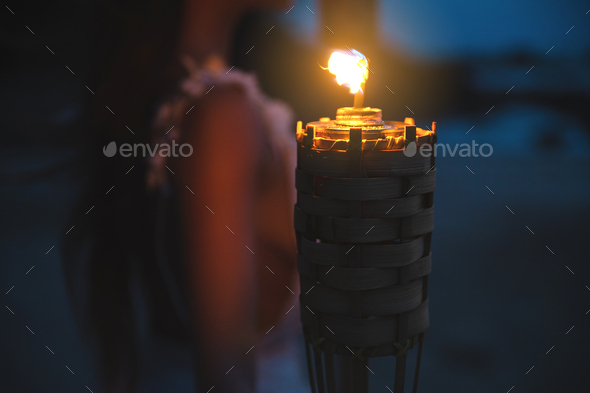 Close-up of bamboo torch light on the beach