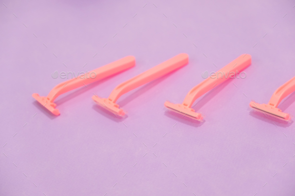pink women's disposable razors .