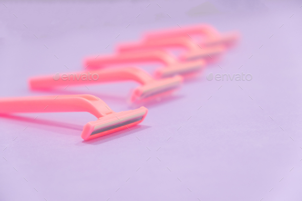 pink women's disposable razors .