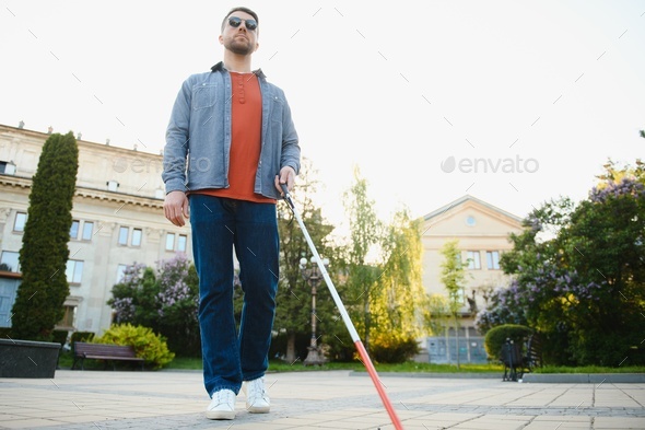 Blind Man Walking On Sidewalk Holding Stick Wearing Armband Stock Photo,  Picture and Royalty Free Image. Image 48226824.