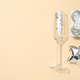The concept of celebrating the New Year 2024, a glass with glitter and a gift - PhotoDune Item for Sale