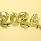 New Year 2024 with golden balloons on a light background - PhotoDune Item for Sale
