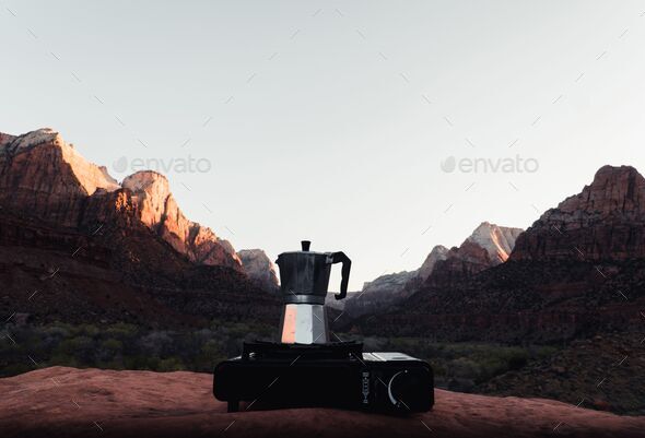 Moka Pot on a portable stove with rocky mountains in the background