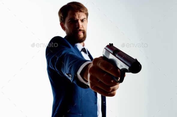 One caucasian man detective secret agent criminal with gun in silhouette  studio isolated on white