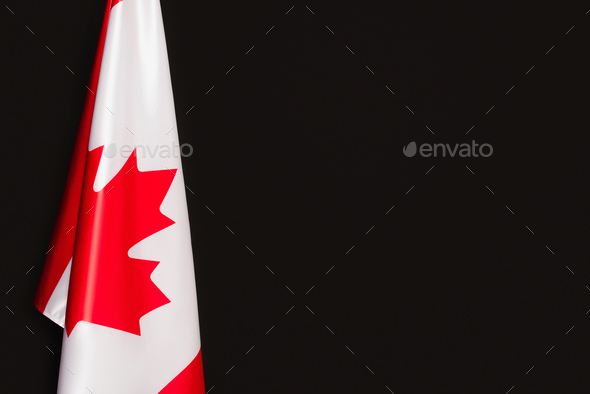 white canadian flag with red maple leaf isolated on black