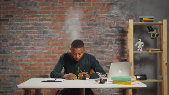 AfricanAmerican Technician Scared of Short Circuit in Lab alt