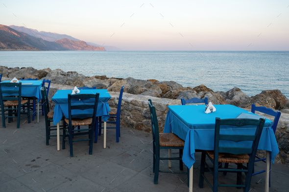 Empty beach tavern restaurant at Paleochora town, Crete island Greece. Rocky landscape, sea, sky.