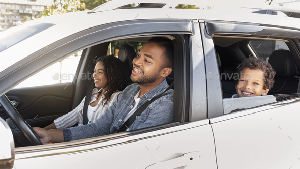 Happy friendly black family riding car traveling by automobile - Stock Photo - Images