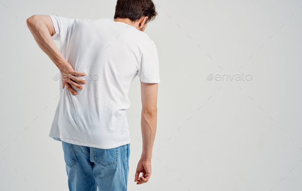 man in white t-shirt back pain osteochondrosis of the spine model back view